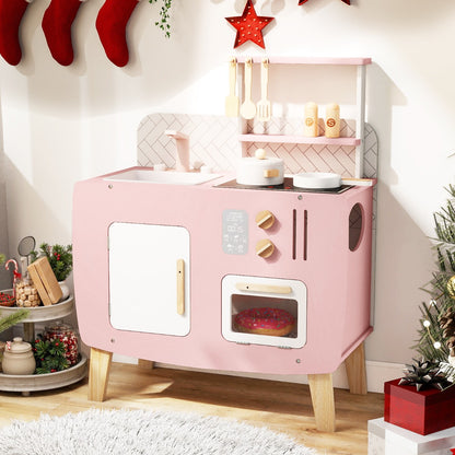 The play kitchen set decorated for Christmas with festive ornaments nearby