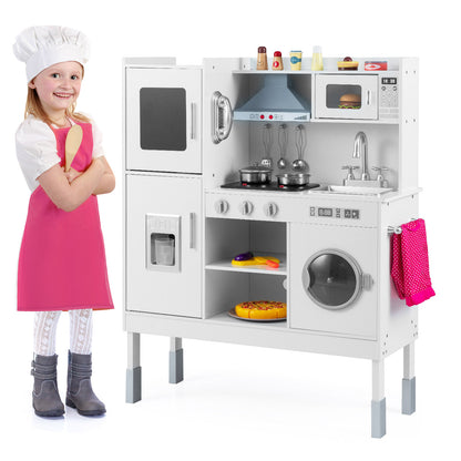 The play kitchen set standing next to a young girl dressed as a chef in a pink apron