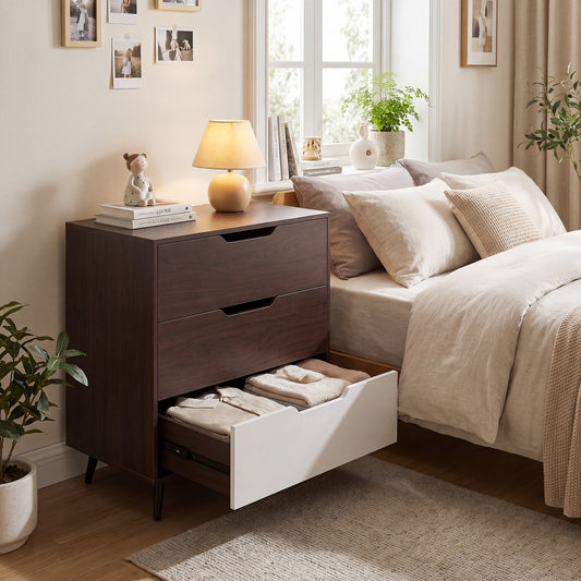 The wooden nightstand placed beside a bed with the bottom drawer pulled open
