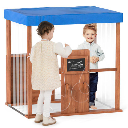 Two children interacting at the wooden outdoor gas station playset
