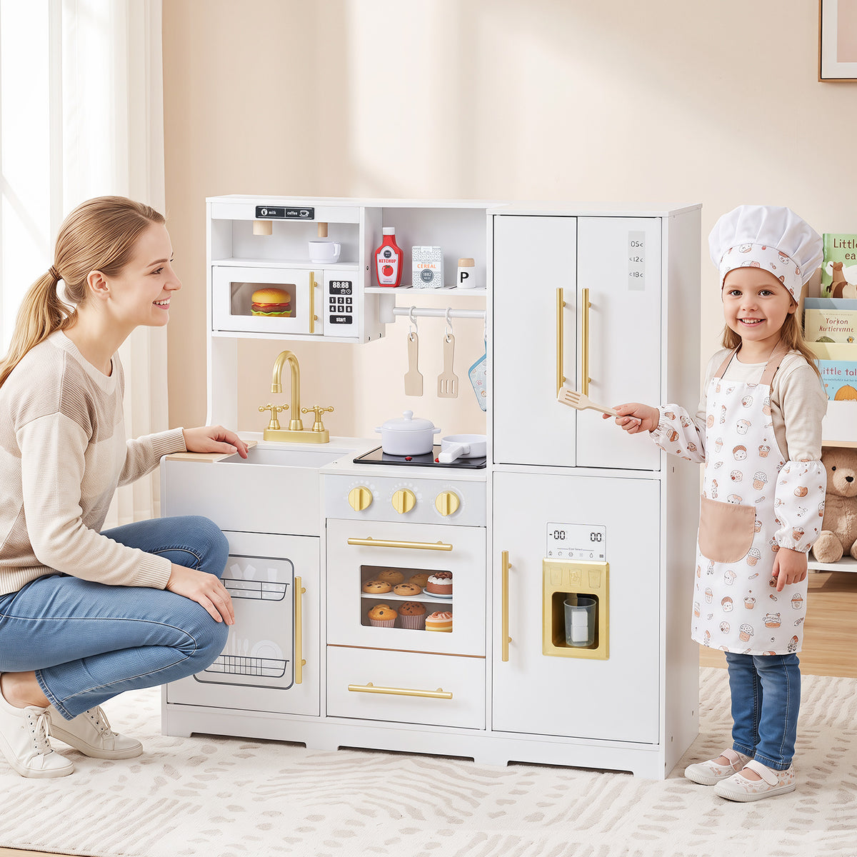 A mother and child interact with the white wooden play kitchen set