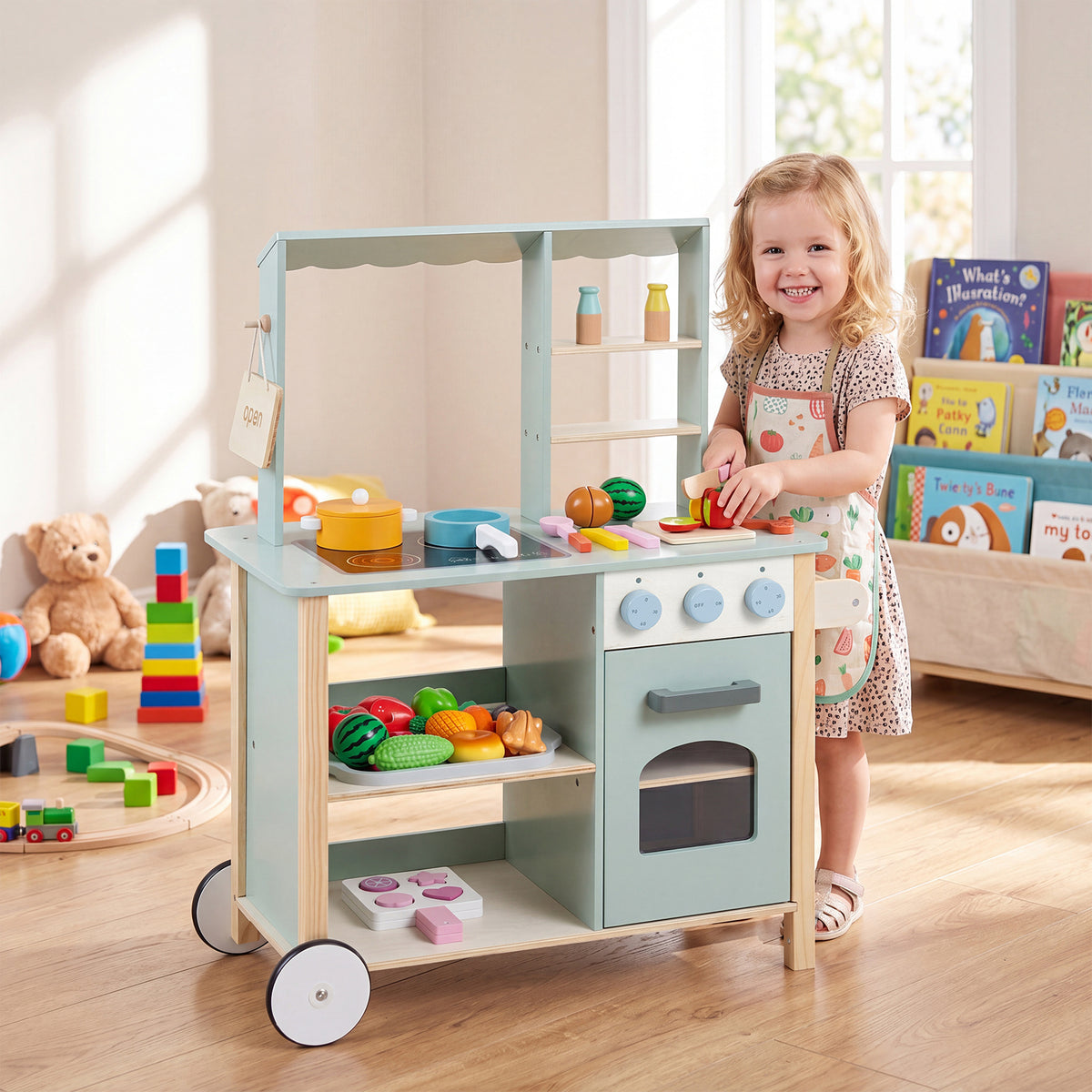 The kids play kitchen with a little girl playing with the accessories