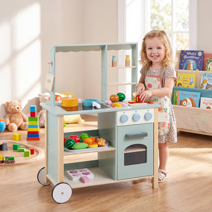 The kids play kitchen with a little girl playing with the accessories