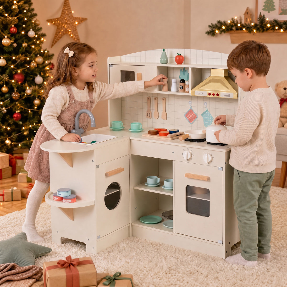 The play kitchen set being used by two children in a room decorated for Christmas