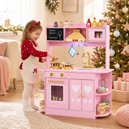 The play kitchen set being used by a young girl in a festive room with a decorated Christmas tree