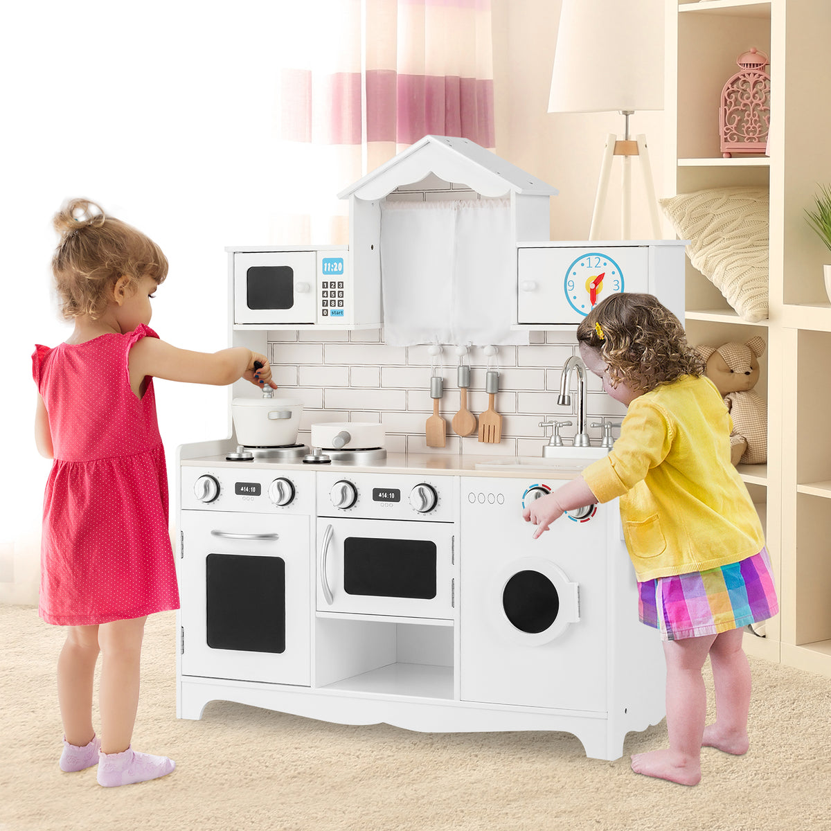 Two young children playing with the wooden pretend kitchen set