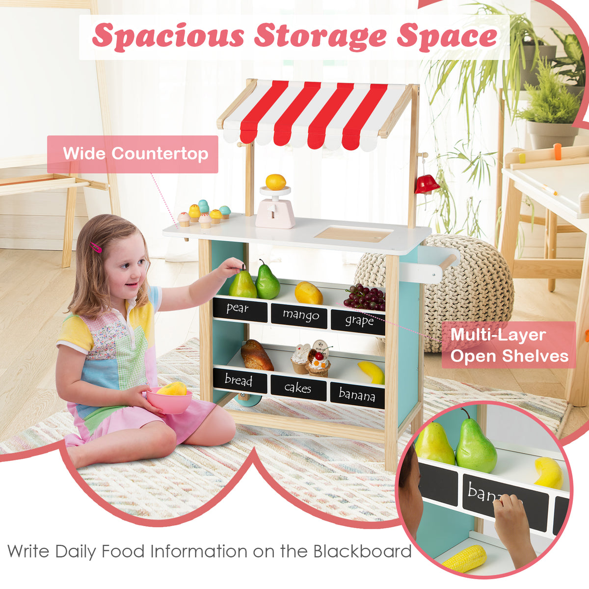 A young girl playing at the wooden grocery store, writing on the chalkboard and placing fruit on shelves