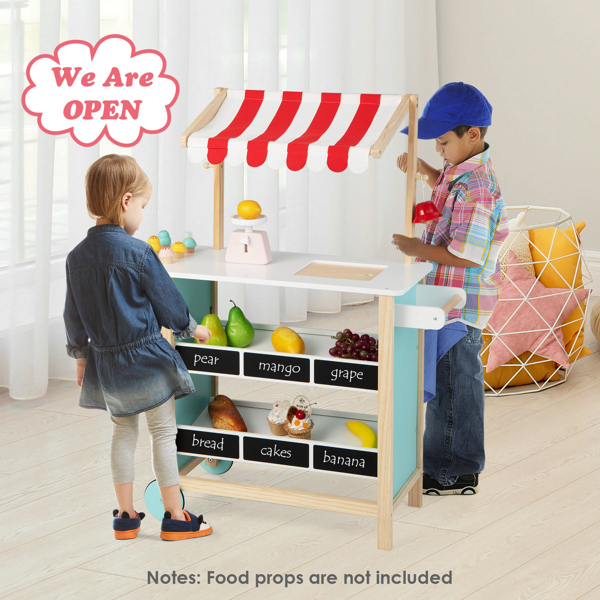 Two children playing at the wooden grocery store, stocking shelves and serving customers