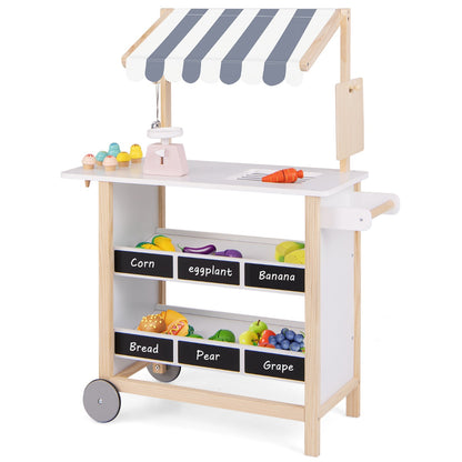 The play kitchen set with a striped canopy and shelves filled with wooden play food items