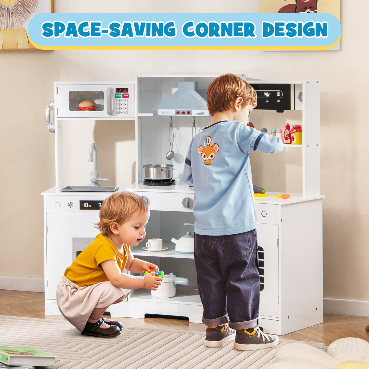 Two young children playing with the white play kitchen in a room