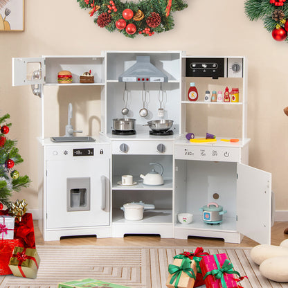 The white play kitchen is set up with festive Christmas decorations around it
