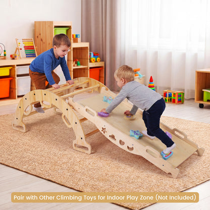 Two children playing on the wooden climbing frame in a playroom