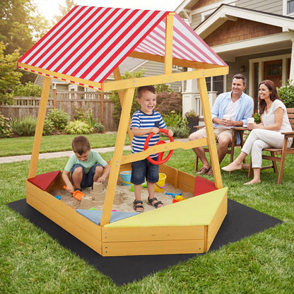 Family enjoying the wooden ship sandpit in a garden setting
