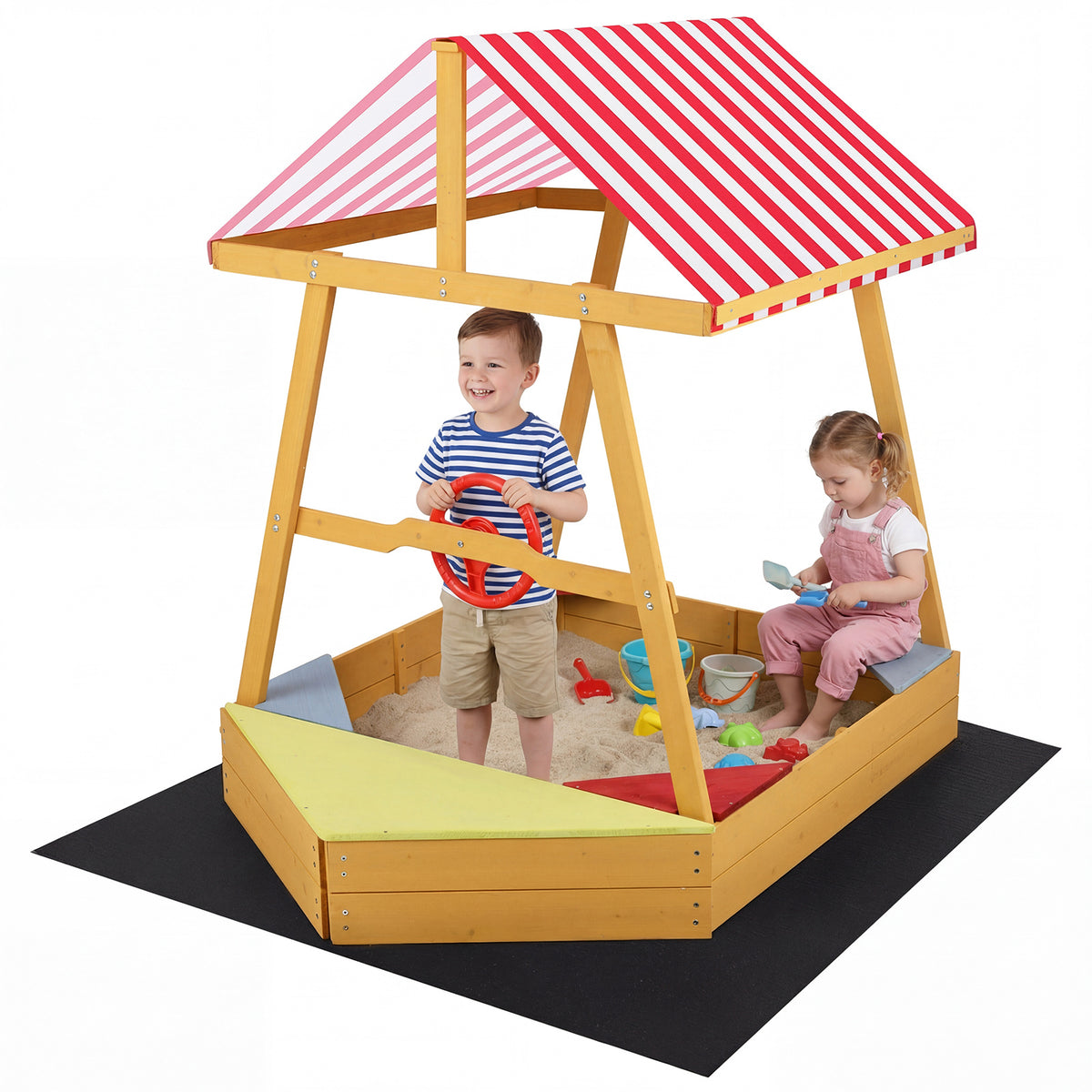 Two young children playing together in the wooden ship sandpit