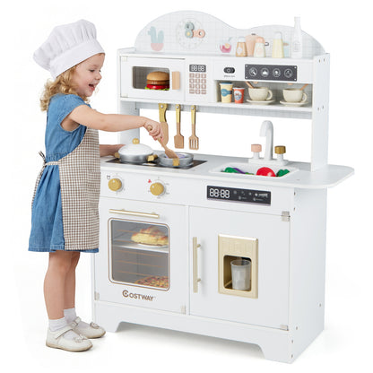 A young girl in a chef's hat uses the white play kitchen set, stirring a pot