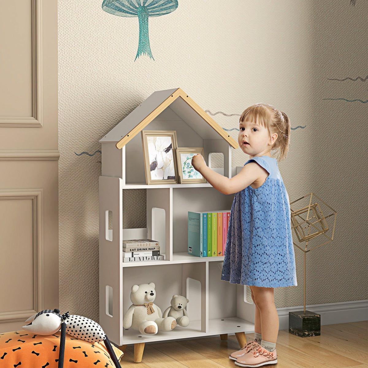 The kids storage unit placed in a child bedroom with a young girl standing beside it